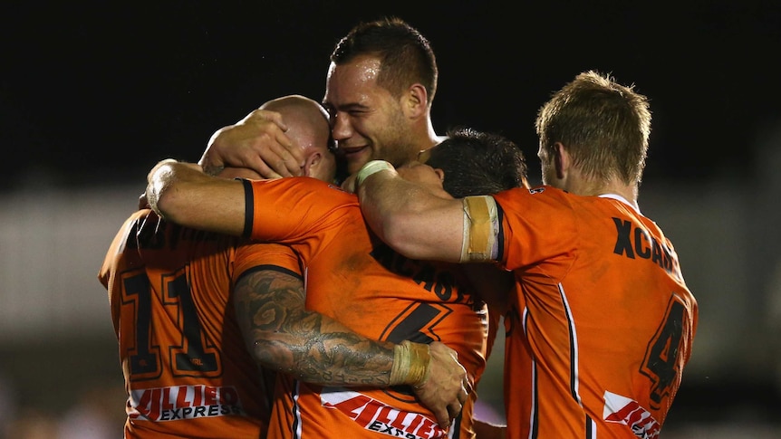 Bodene Thompson celebrates a Wests Tigers try