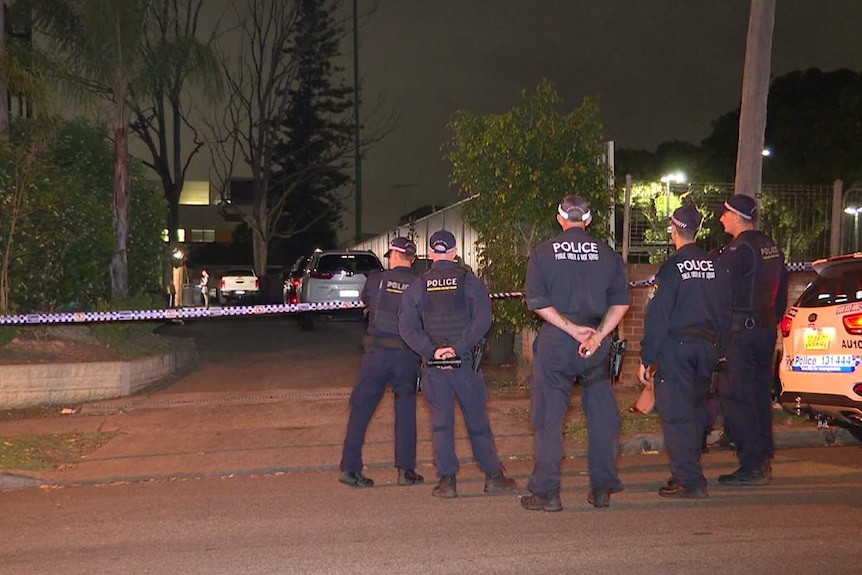 Police officers outside a house