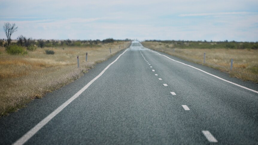 The Landsborough Highway runs to the horizon.