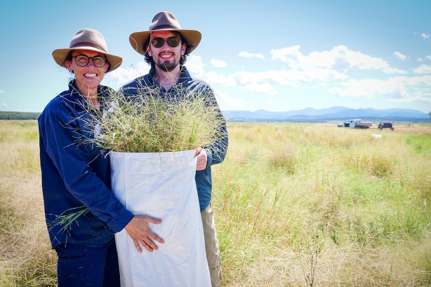 A woman and man with a bag of grass.