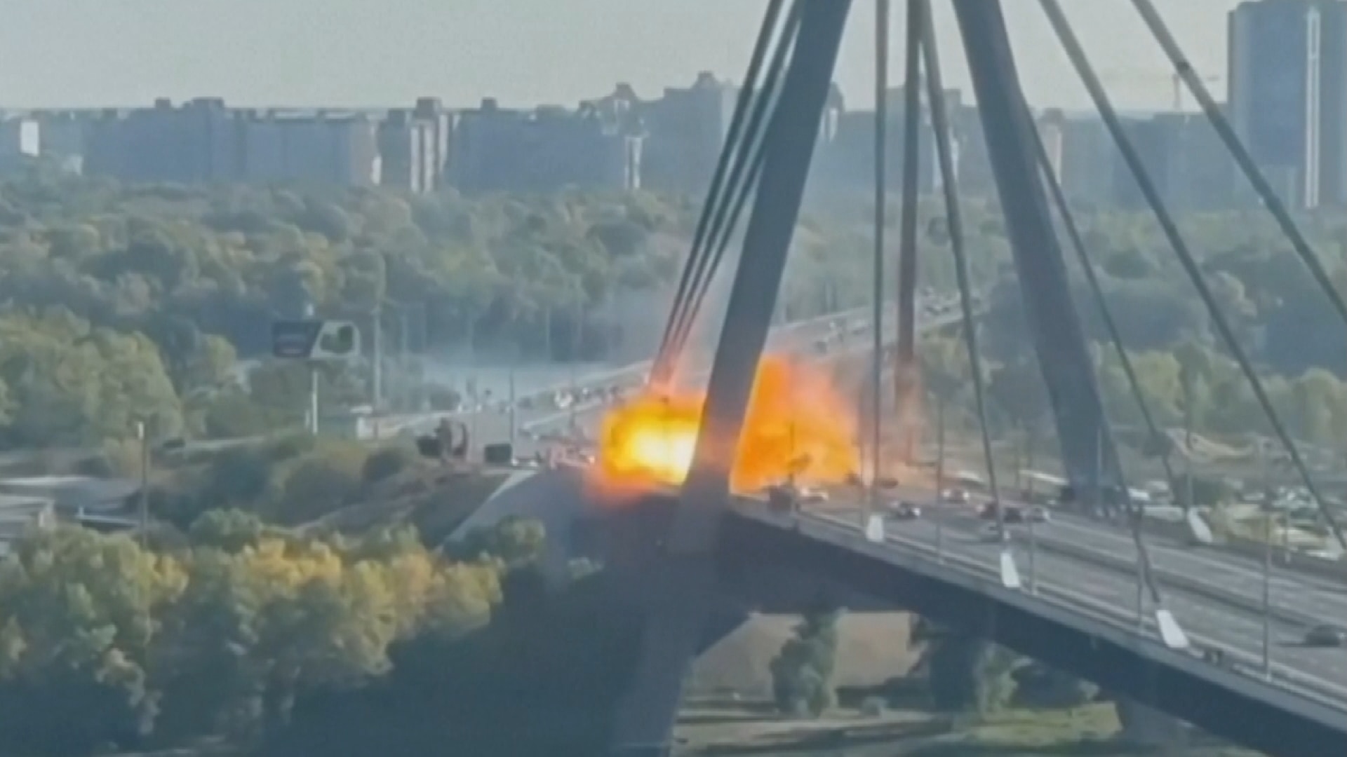 An explosion on a bridge with moving vehicles 