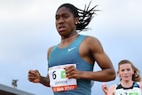 Caster Semenya runs ahead of another woman in a 3,000m race.