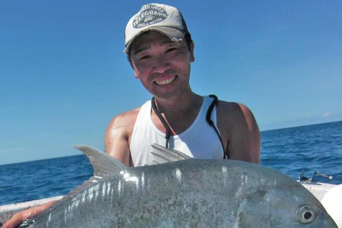 Junichi Yoshimura holds up a fish.