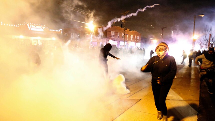Ferguson protesters run from tear gas