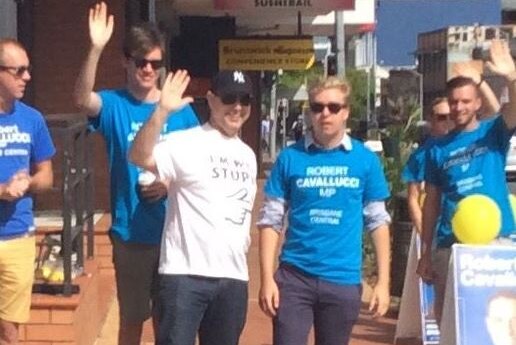 The man posing with LNP volunteers before his arrest.