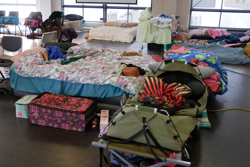 Swags and sleeping bags sprawled out into a room.