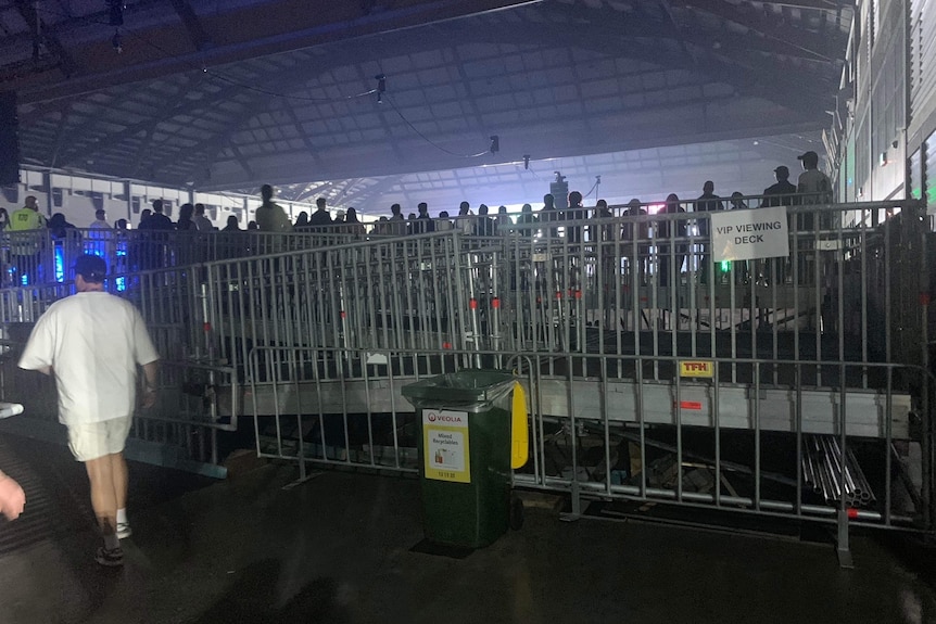 A ramp with rails in the crowd of a music festival