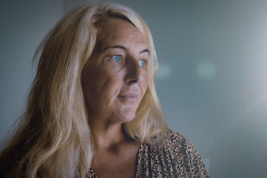 Nicola Gobbo, a woman with blonde hair and blue eyes, glances to the right.