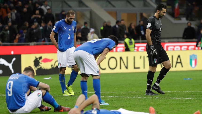 Italian players react to their elimination by Sweden in the World Cup play-off in Milan.