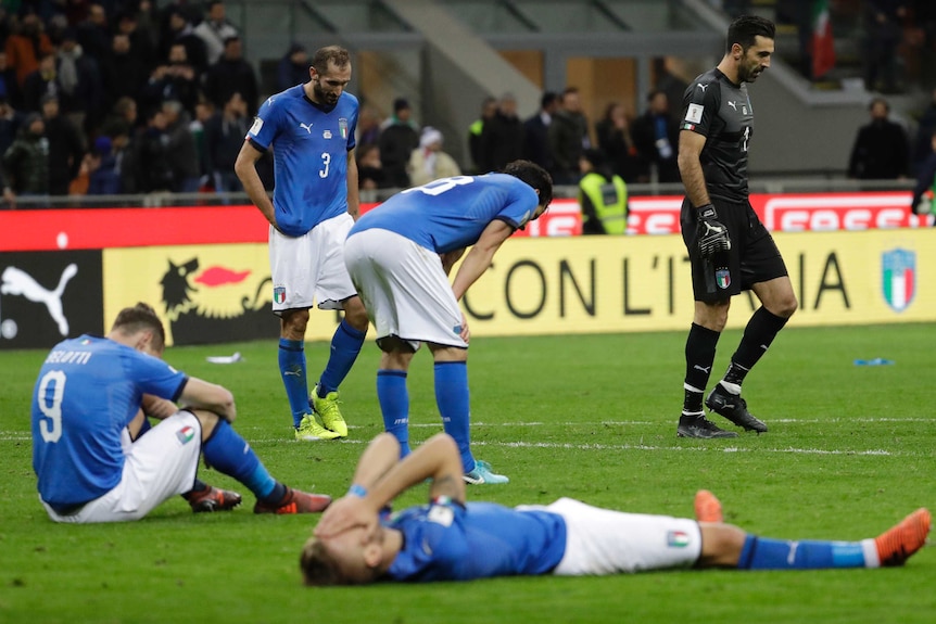 Italian players react to their elimination by Sweden in the World Cup play-off in Milan.