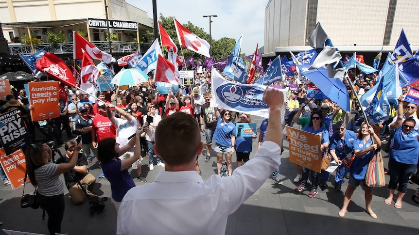 Union members rally with flags and banners