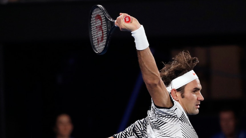 Roger Federer plays a backhand in the Australian Open final.