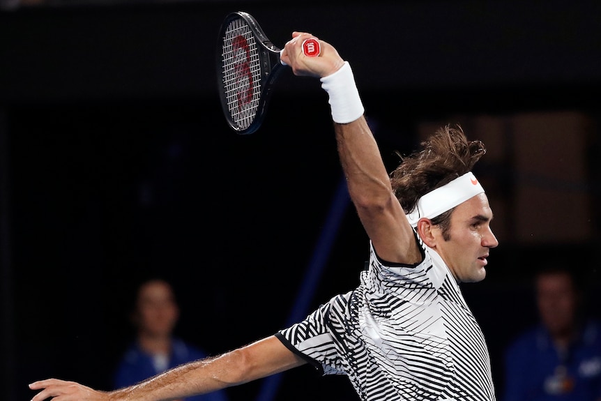 Roger Federer plays a backhand in the Australian Open final.