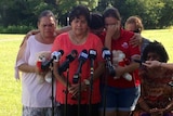 A crying family at a press conference in Townsville.