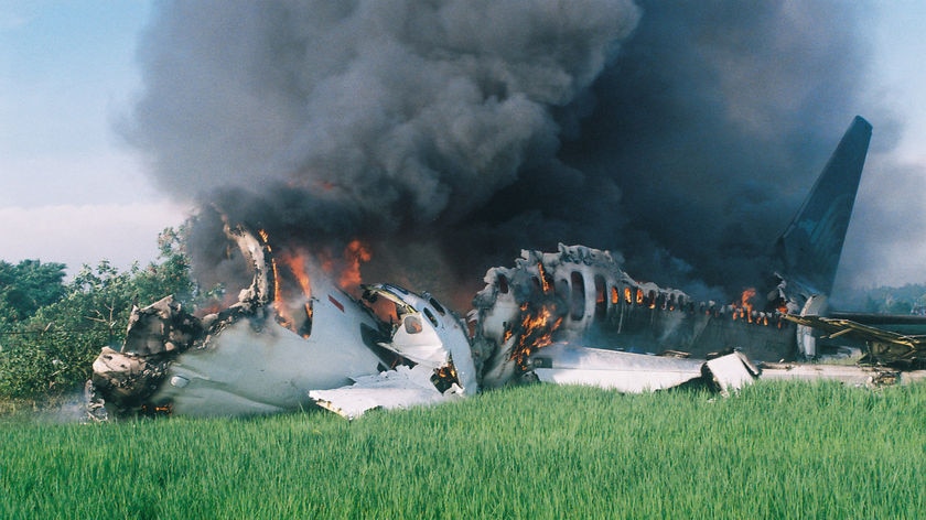 Pilot ignored warnings not to land: Smoke pours from the wreckage of the Garuda jet at Yogyakarta airport