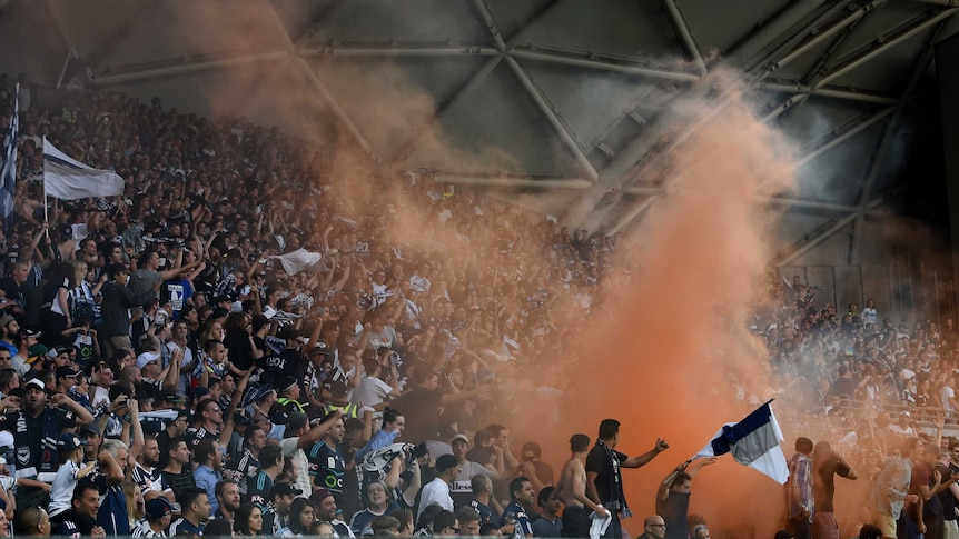 Melbourne Victory fans light a flare