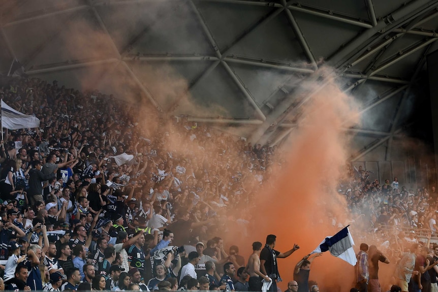 Melbourne Victory fans light a flare