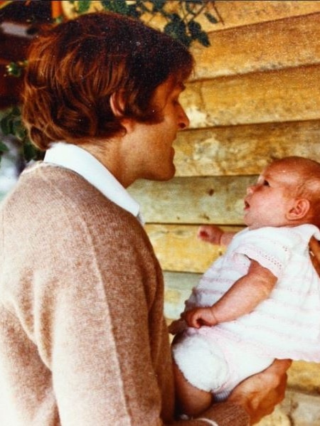 Bruce Fairfax holds his daughter.