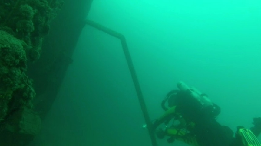 Divers on the wreck of the HMAS Perth