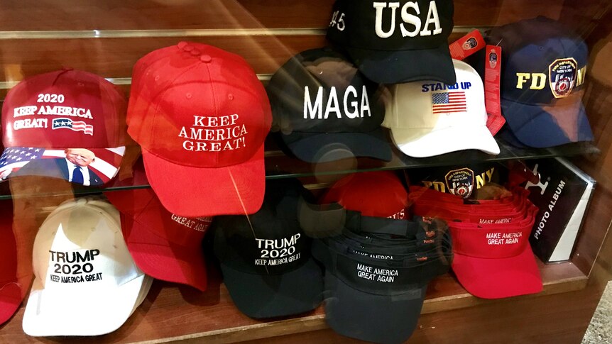 themed hats, including trump hats, on a shelf