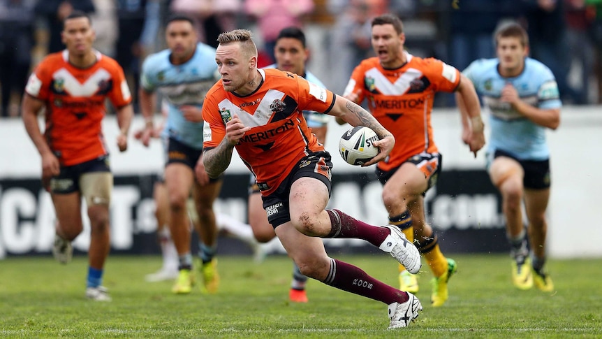 Wests Tigers' Blake Austin makes a break against Cronulla in round 26, 2014 at Leichhardt Oval.