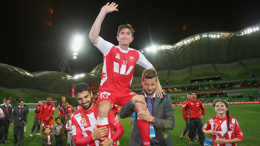Last hurrah ... Harry Kewell is chaired off the field after playing his final match