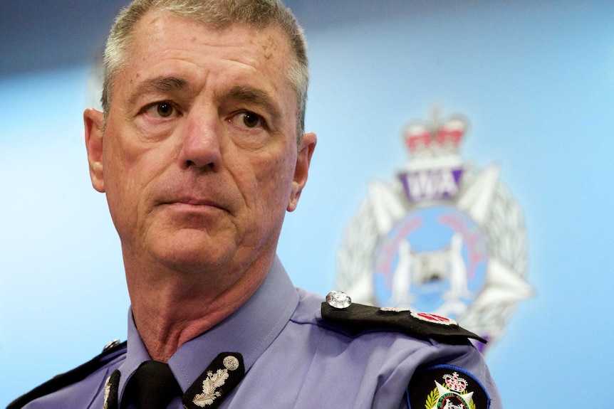 A tight head shot of then-WA Police Commissioner Karl O'Callaghan in a media conference.