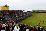 A view from the grandstand of the 18th green and leaderboard as the winner putts out at The Open.
