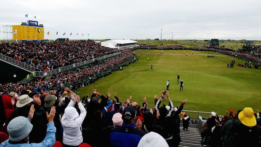 A view from the grandstand of the 18th green and leaderboard as the winner putts out at The Open.