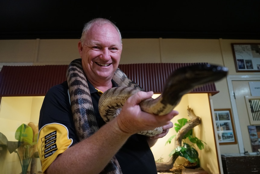 Alice Springs Reptile Centre owner Rex Neindorf holds a snake.