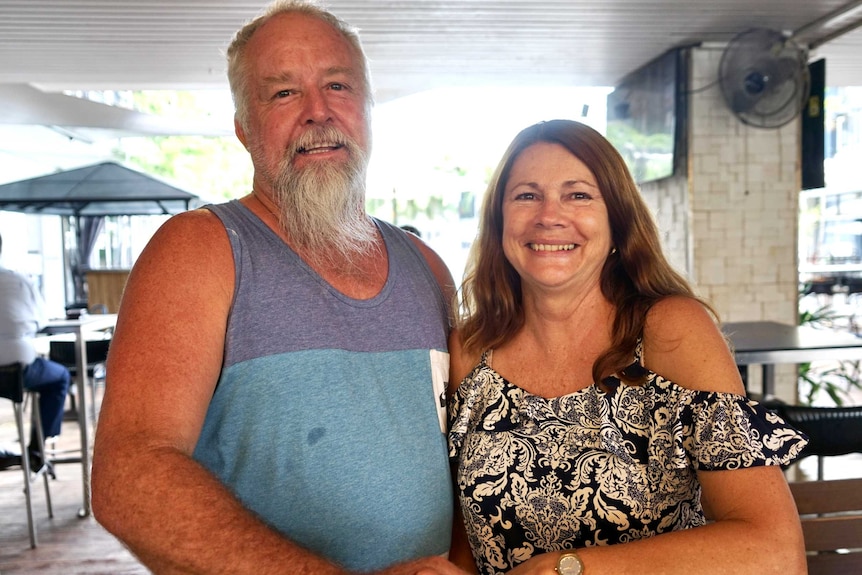 A photo of an elderly couple at a pub, smiling.