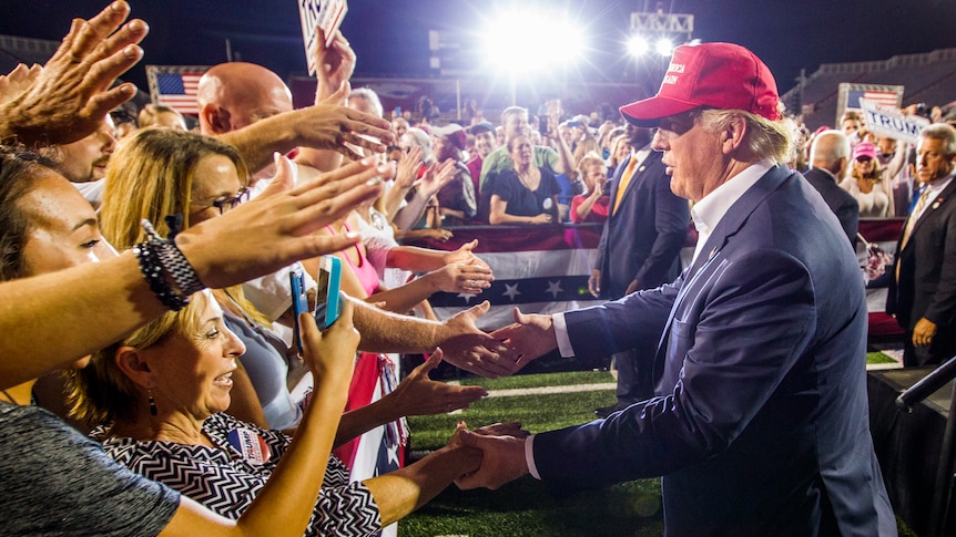 Donald Trump greets supporters after his rally at Ladd-Peebles Stadium in Mobile, Alabama.