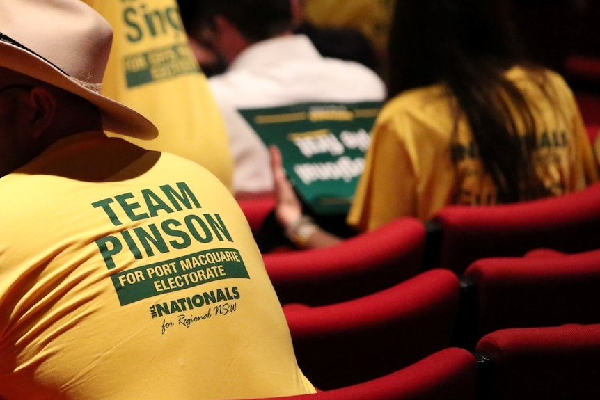 Photo of Nationals supporters sitting in a theatre from behind. 