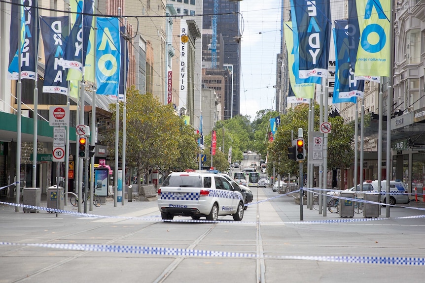 A police car on an empty Bourke Street after a car ploughs into pedestrians.