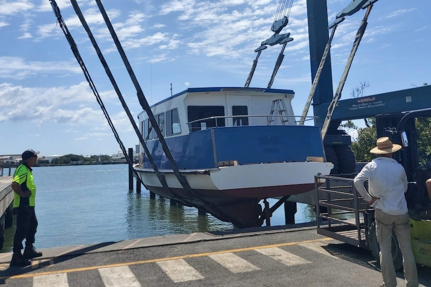 Wooden ferry on sling going into river