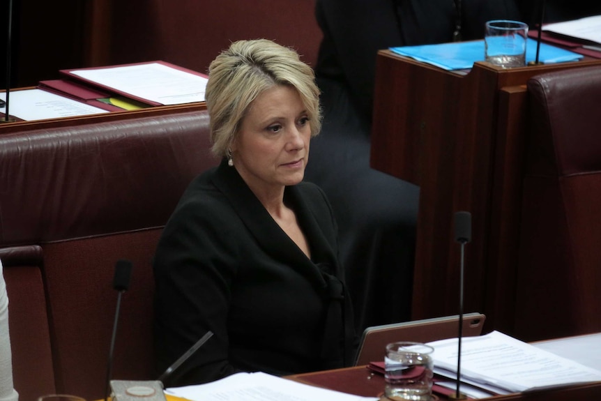 Keneally looks despondent as she sits in the Senate chamber.