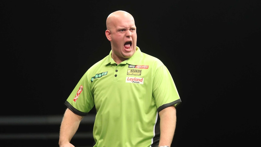 Michael van Gerwen screams with his arms down by his side, hands clenched in fists