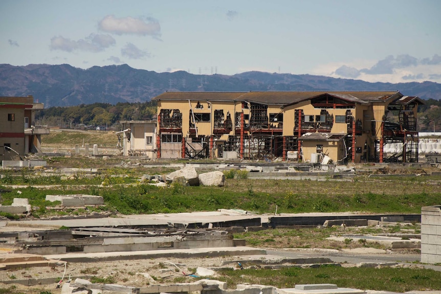 Debris and a decrepit building near Fukushima, Japan.