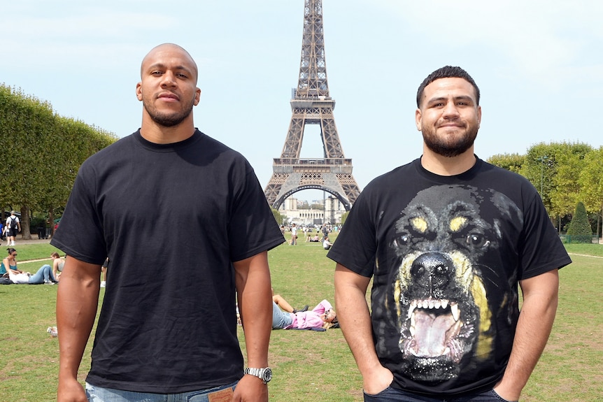 Ciriyl Gane stands next to Tai Tuivasa in front of the Eiffel Tour