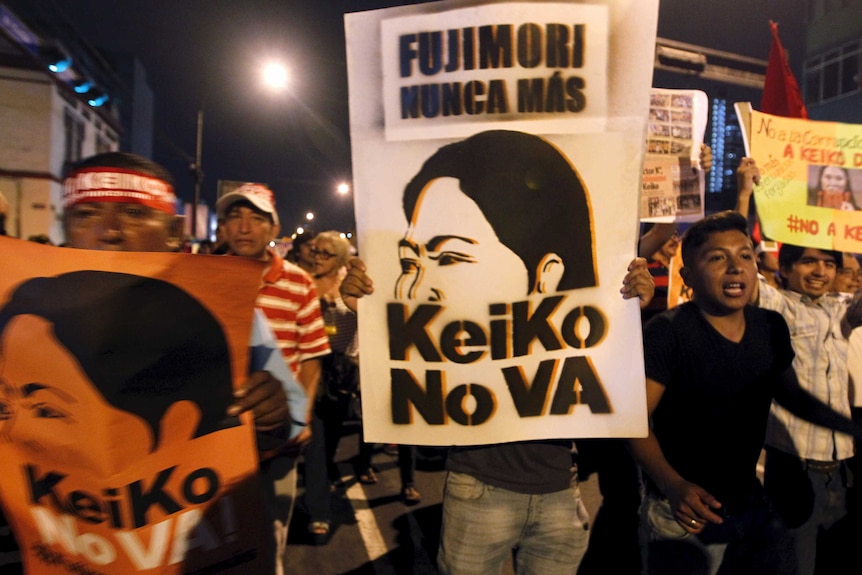 Protesters holding a sign that reads, "Fujimori never again".