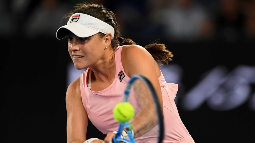 Kimberly Birrell stares ahead as she plays a double-fisted backhand at the Australian Open.