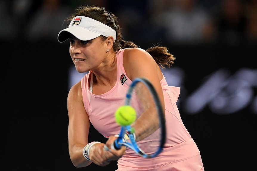 Kimberly Birrell stares ahead as she plays a double-fisted backhand at the Australian Open.