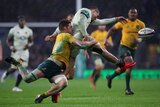 England's Jonny May kicks a football while being tackled by the Wallabies' Michael Hooper
