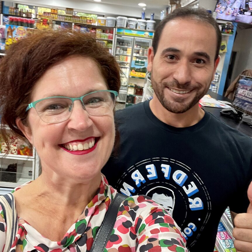 A selfie of a man and a woman in convenience store.