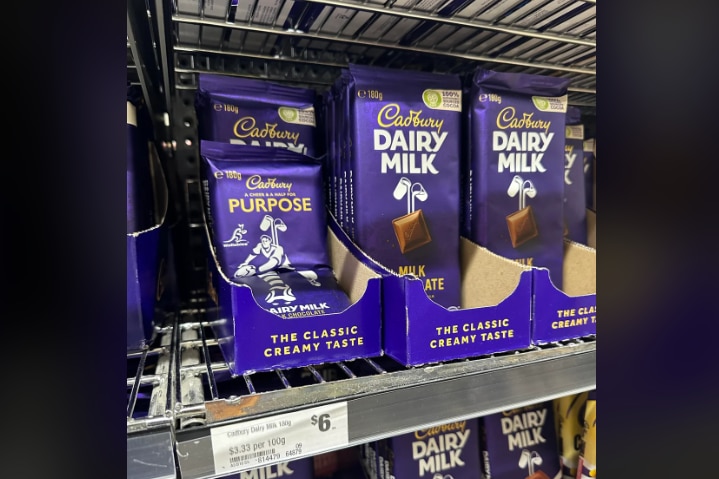 A picture of Cadbury chocolate bars on a supermarket shelf. The price label says $6.