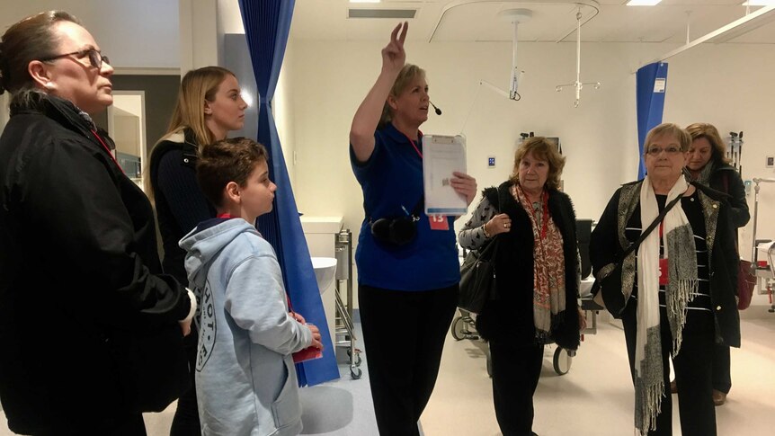 A volunteer leads a group tour of the new Royal Adelaide Hospital.