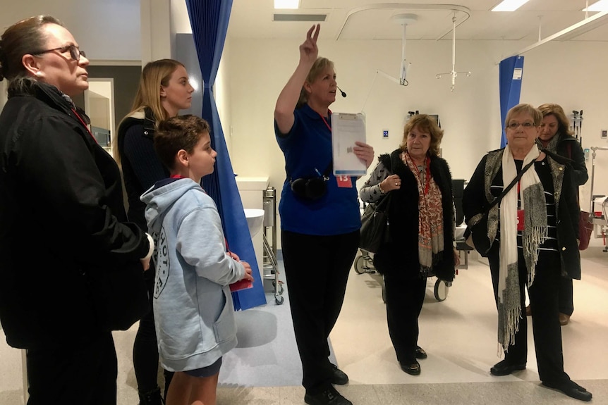 A volunteer leads a group tour of the new Royal Adelaide Hospital.