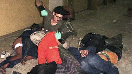 A US soldier appears set to strike a detainee at Abu Ghraib Prison, outside Baghdad.