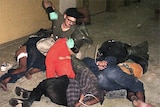 A US soldier appears set to strike a detainee at Abu Ghraib Prison, outside Baghdad.