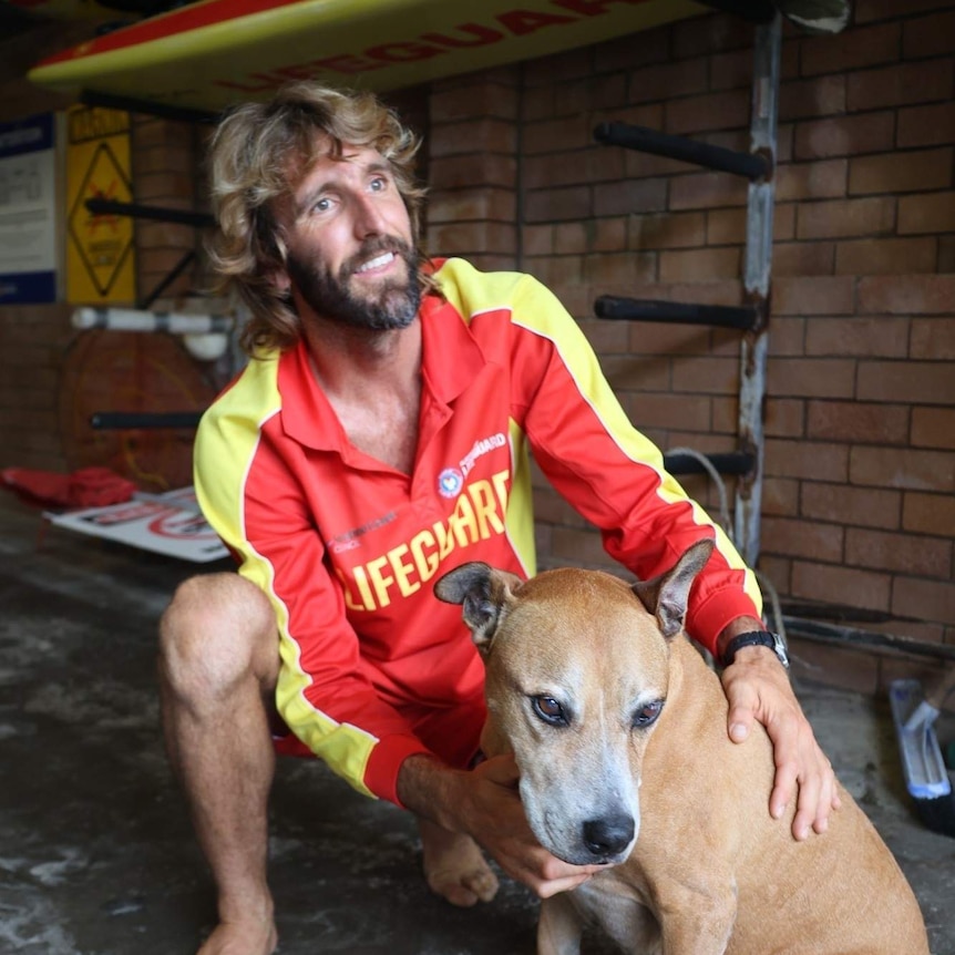 Surf Lifesaver Corey Jones with the sailor's dog.
